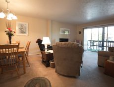 Fully furnished living/dining room with a large patio door